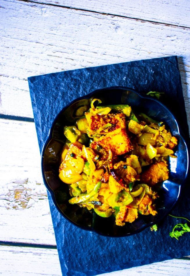 Dhaba Style Paneer Do Pyaza kept on a black plate