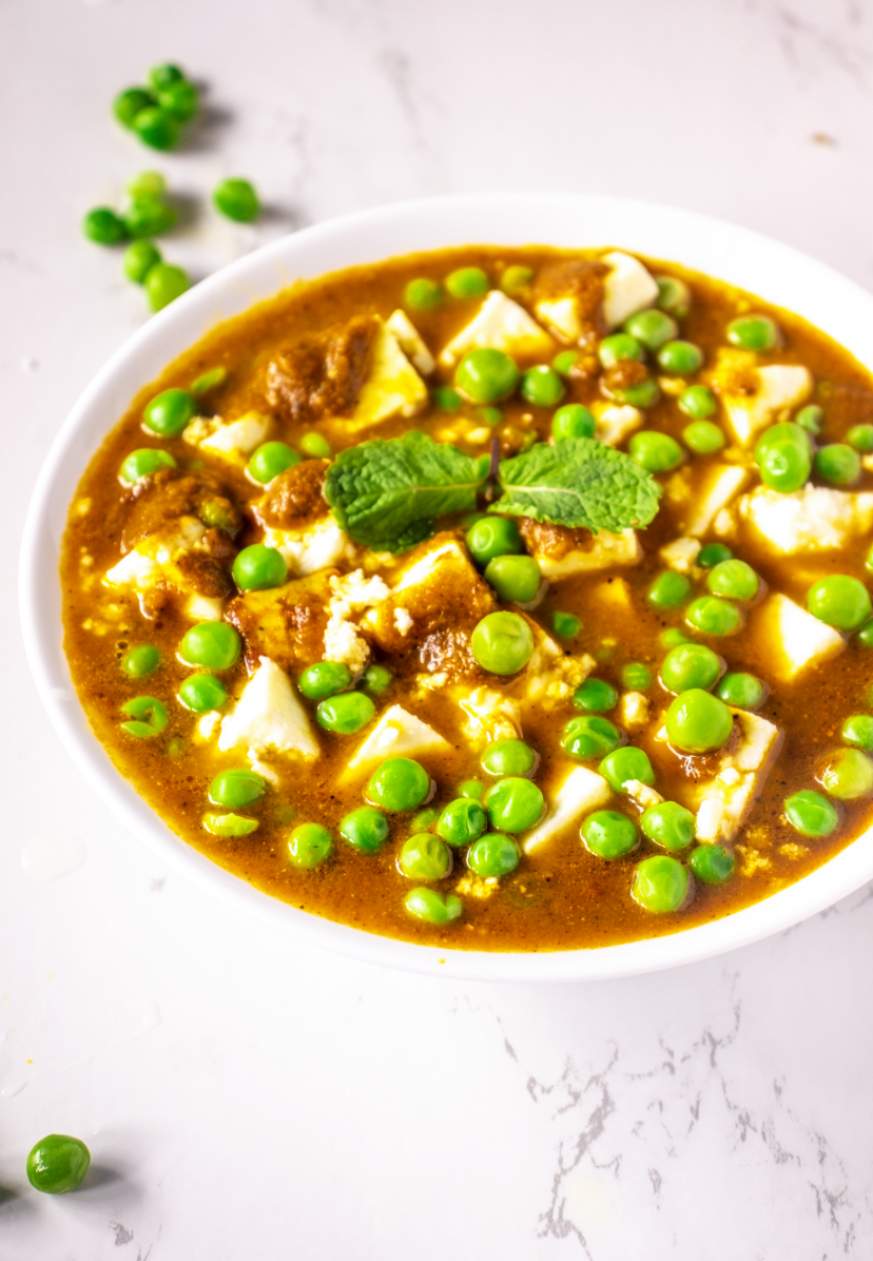 A bowl filled with Matar Paneer