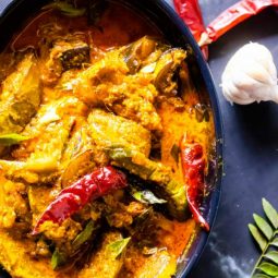 Bengali Dahi Baingan Recipe with garlic and red chili beside