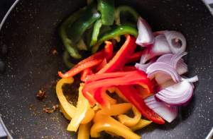 bell peppers and onions being sauteed