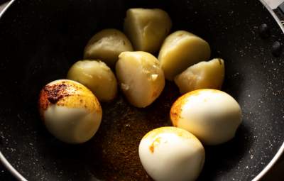 frying the eggs and potatoes