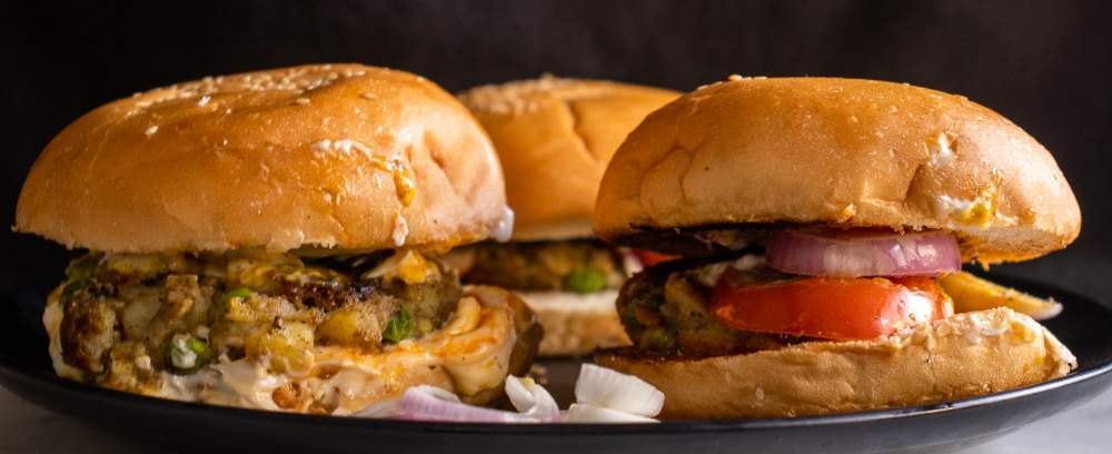 Aloo Tikki Burger kept on a black plate 