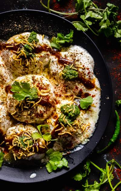 Dahi Bhalla on a plate with coriander leaves