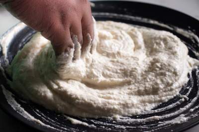 beating dahi bhalla batter with hands