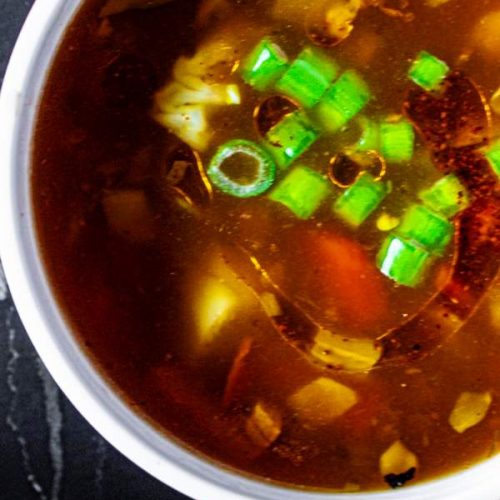 overhead shot of hot and sour soup with garnish