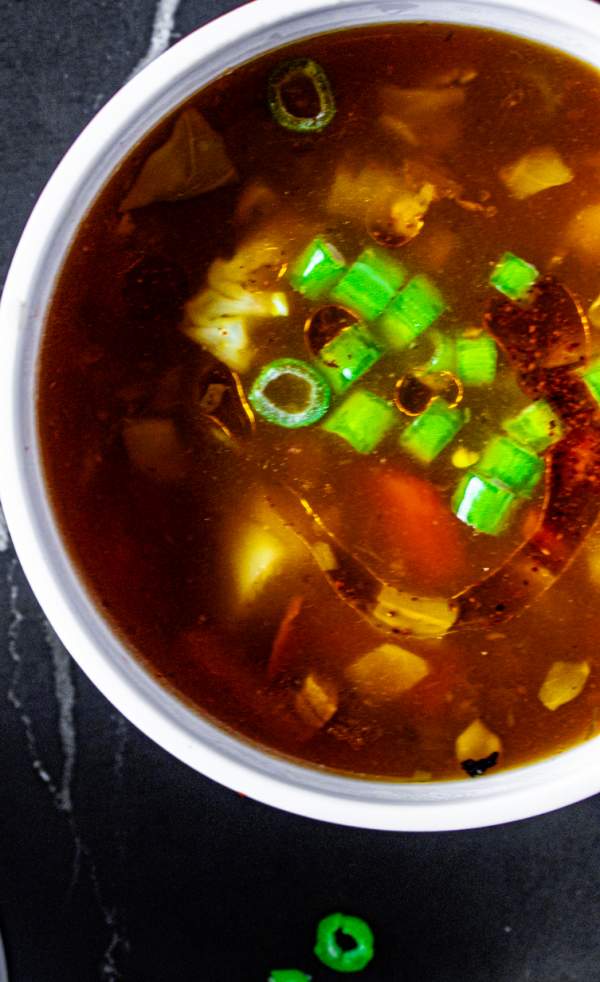 overhead shot of hot and sour soup with garnish