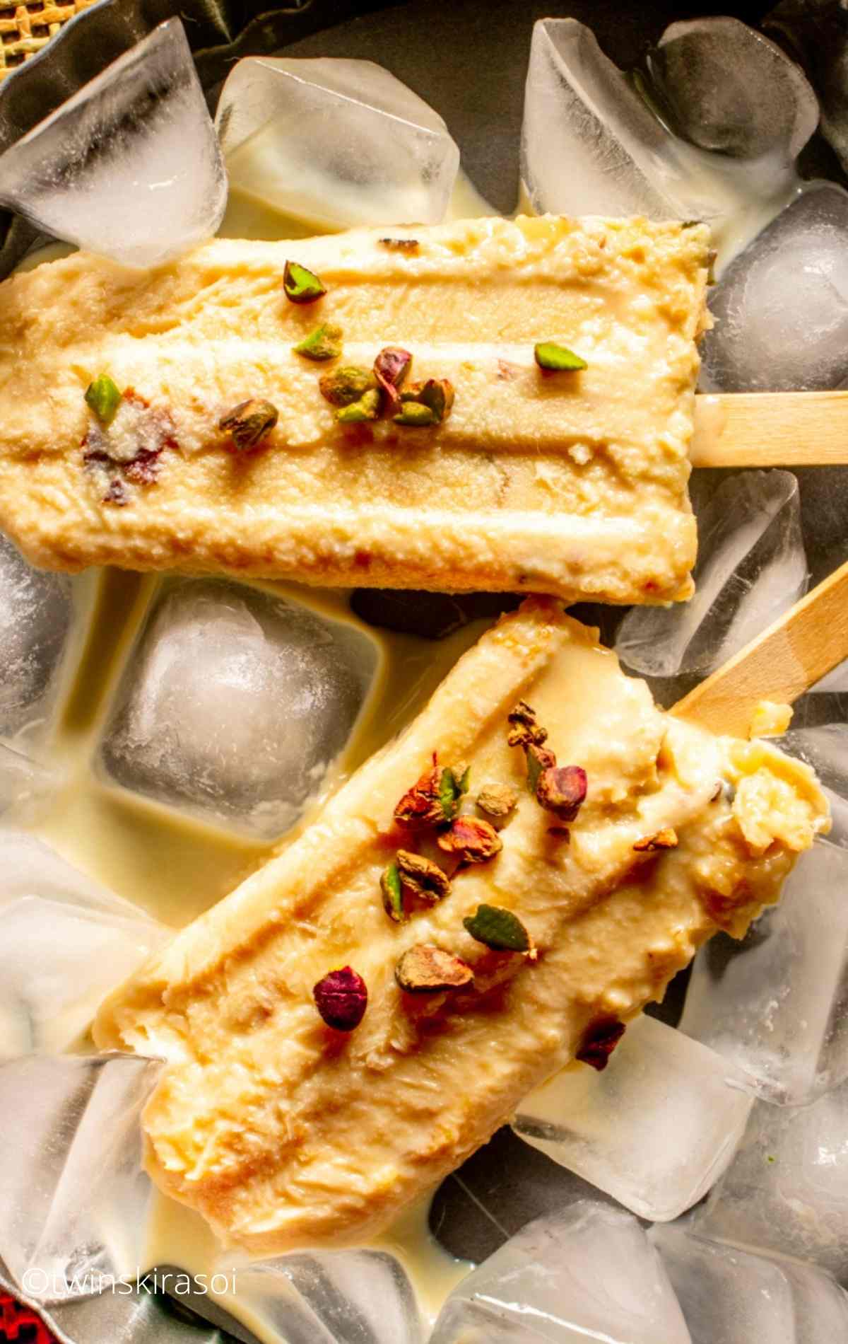 two Malai Kulfi Recipe with Kesar Pista on ice cubes